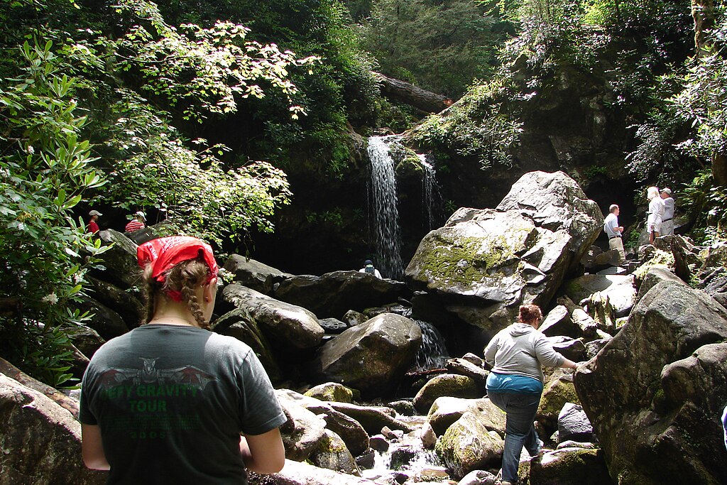 A Person Climbing on Wet Rock