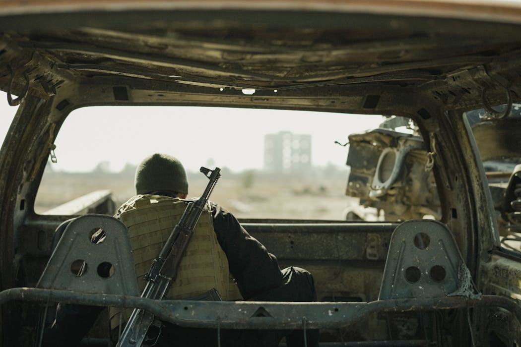 Soldier Observing from Abandoned Vehicle