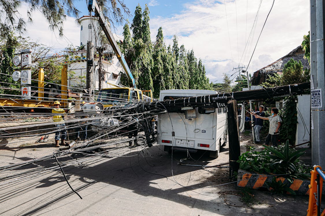 Utility Workers Fix Fallen Power Lines on Street