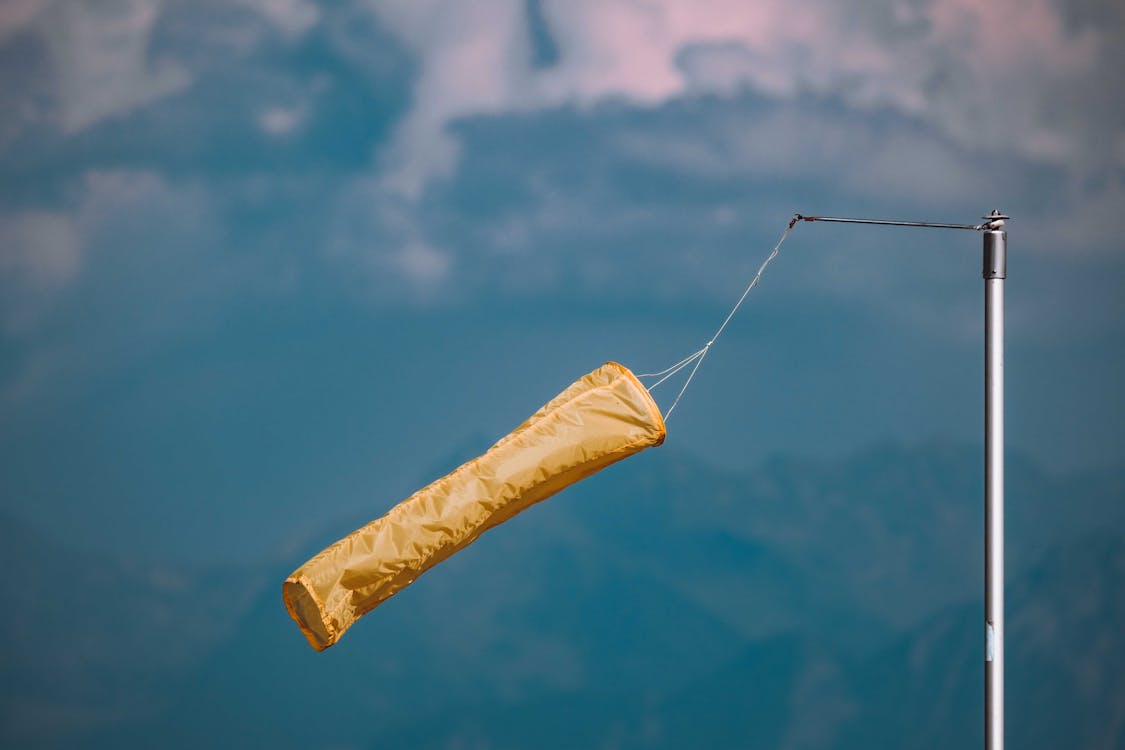 Yellow Windsock Hanging against the Sky