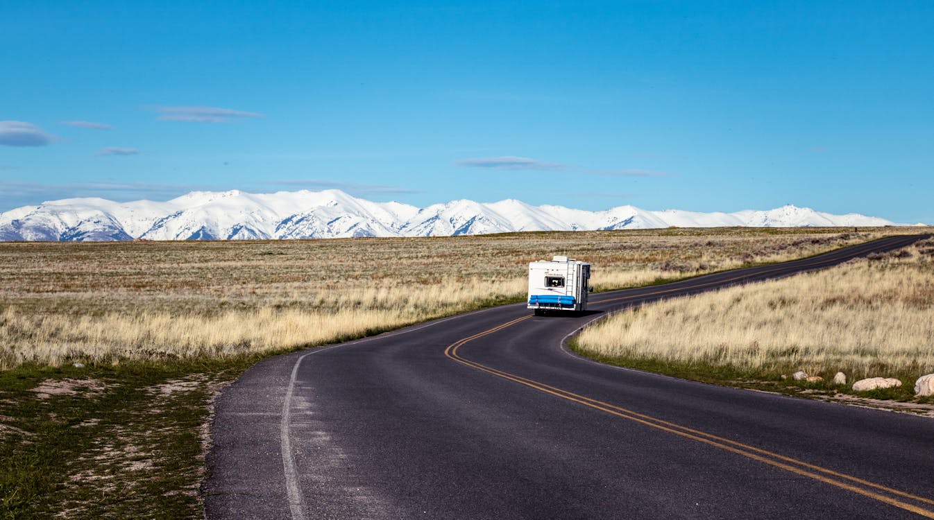 White Vehicle Traveling on Road