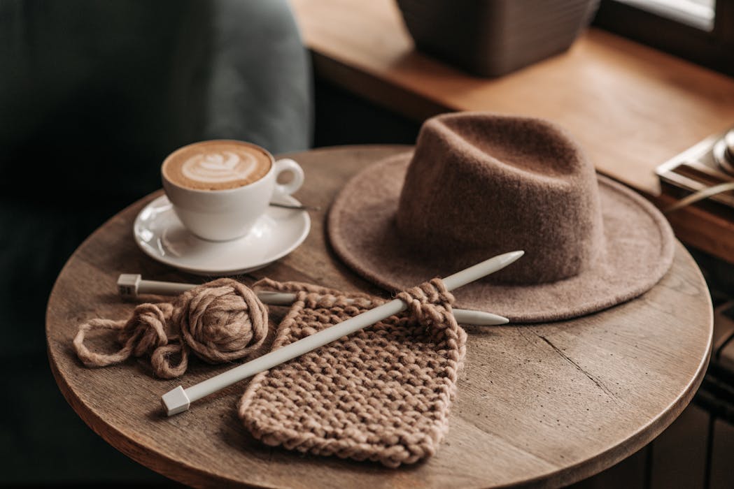 Crochet and Hat on Top of a Round table