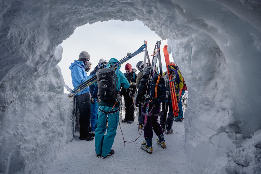 People Making Snow Cave Wearing Layered Cloths
