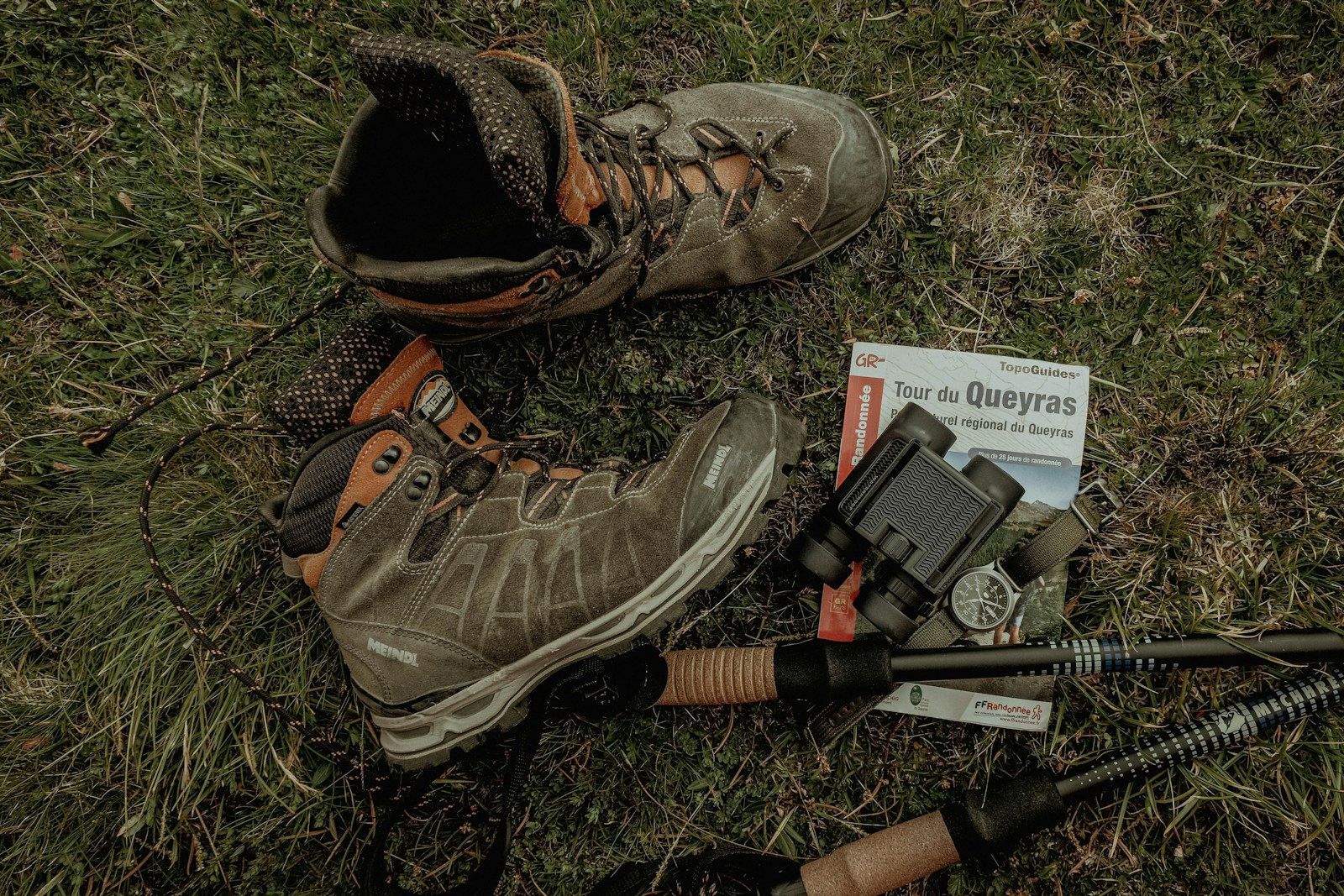 a pair of boots and a gun on the ground