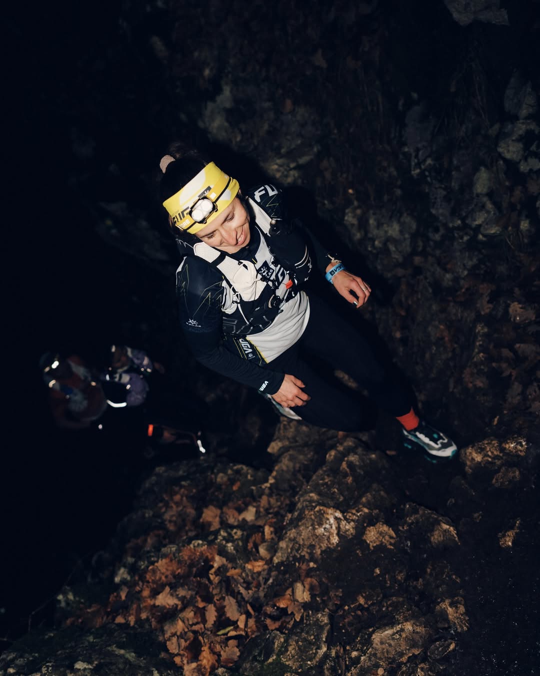 A Woman Using Headlamp in a Cave
