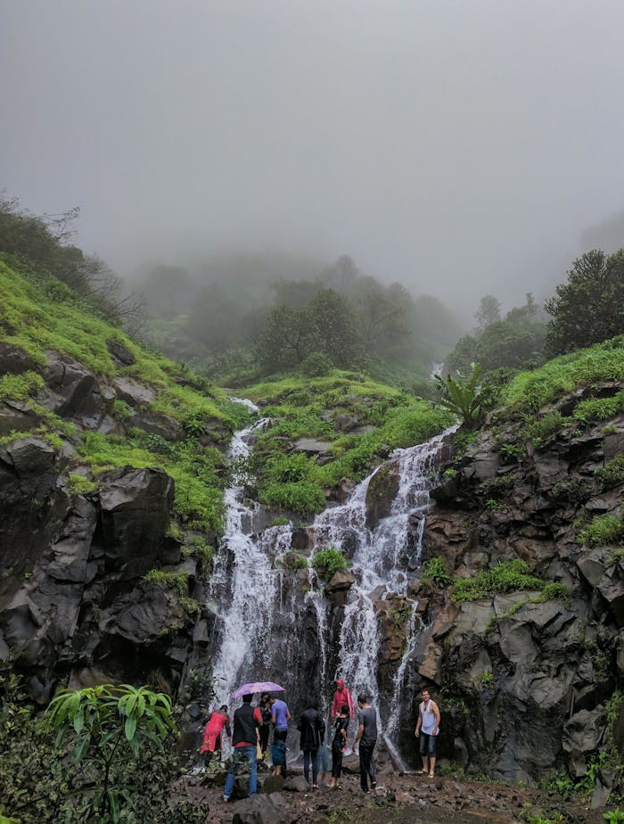 People In Front Of Waterfalls