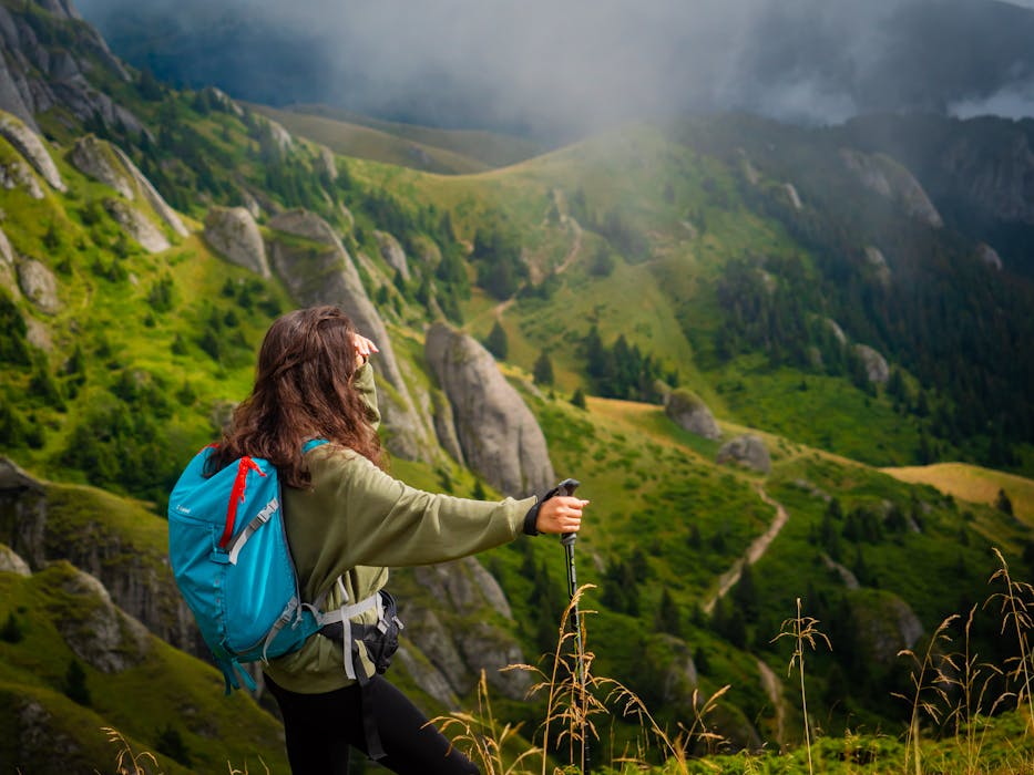 Hiker Leaning on a Trekking Pole Admiring Mountain Views