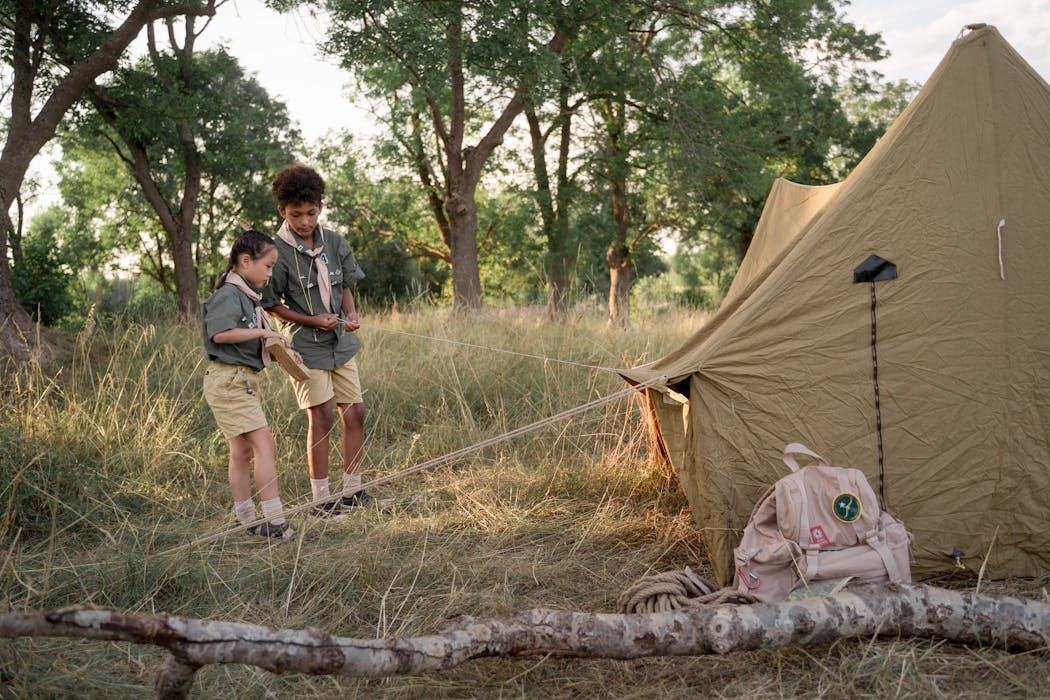 Photo of Kids Setting Up a Tent
