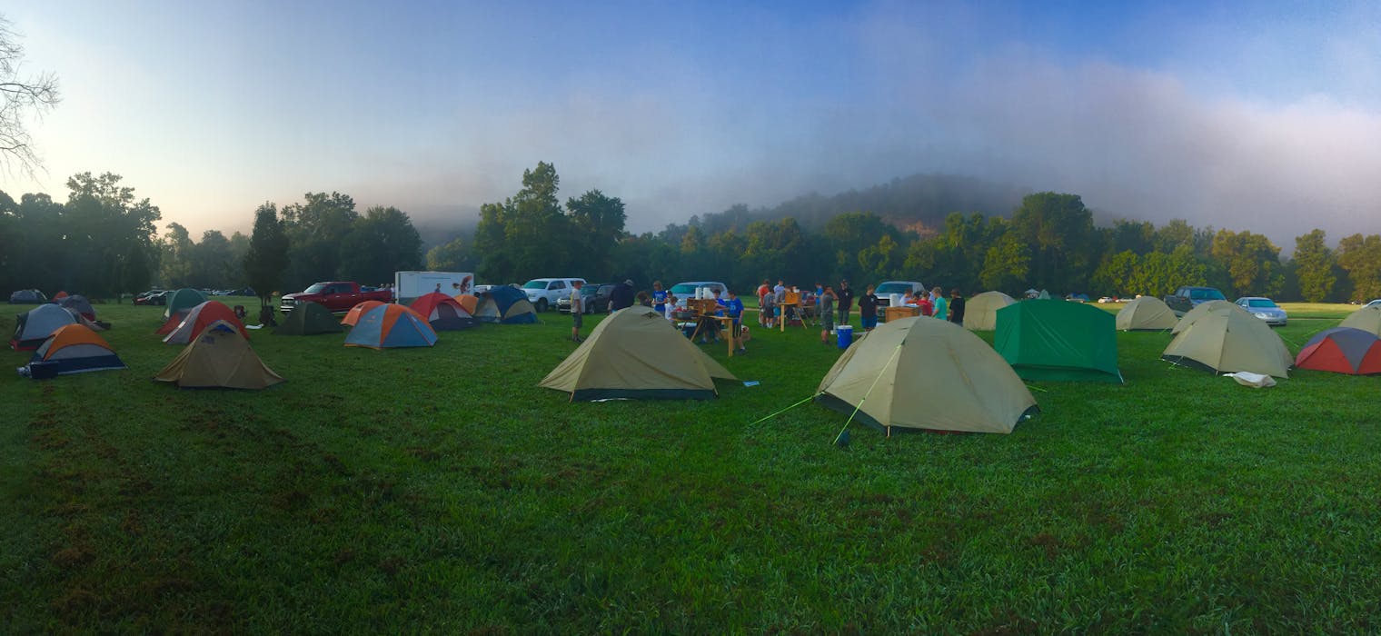 Tents on Green Grass Field Near Mountain