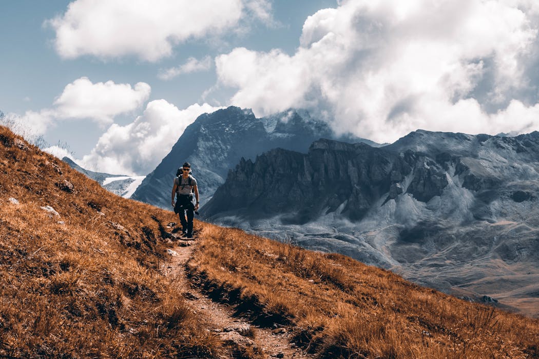 taiki-ishikawa-w6EMxsk8CDA-unsplash Man Hiking Through Mountains