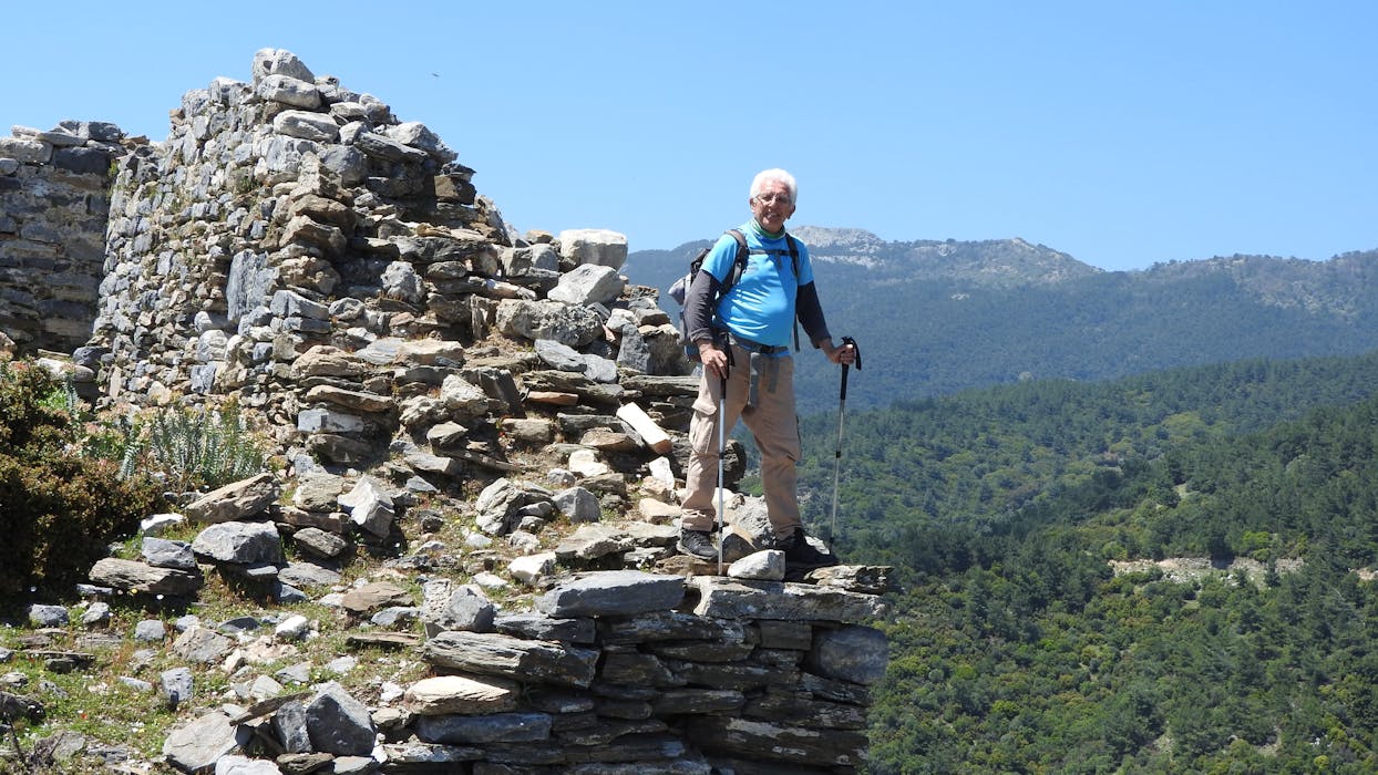 Senior Hiker Exploring Ancient Ruins Outdoors