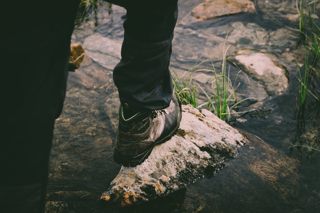 A Person Stepping on a Rock