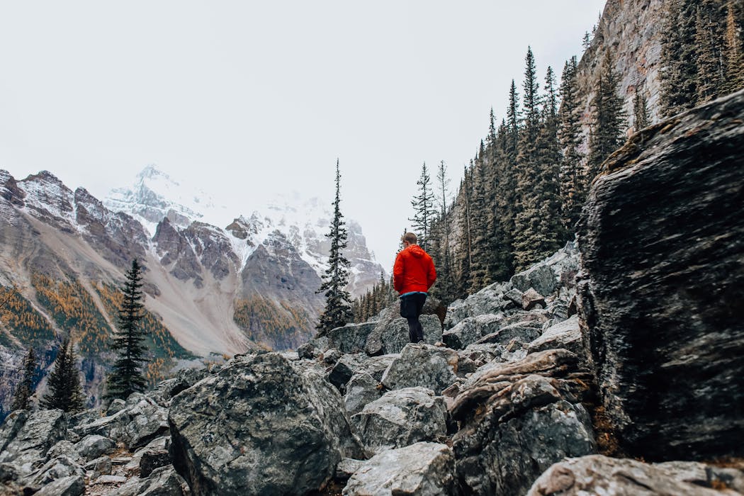 taiki-ishikawa-w6EMxsk8CDA-unsplash Man Wearing Red Jacket Walking on Mountainside