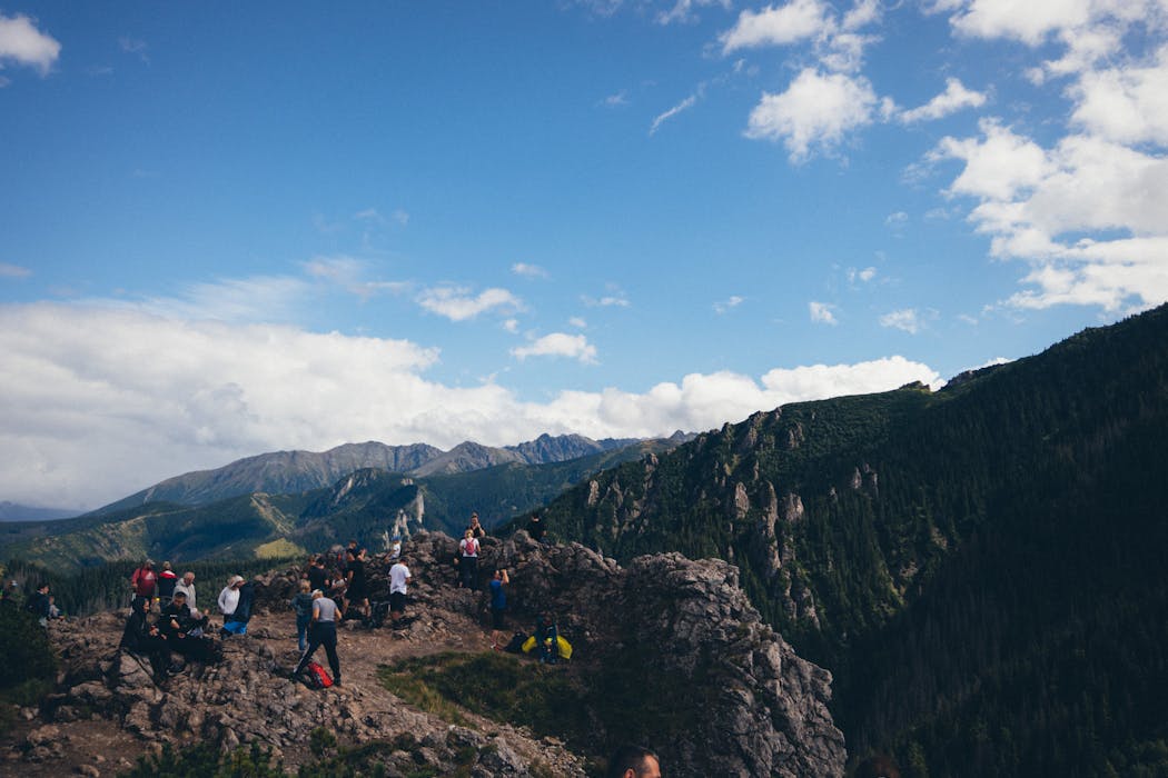 taiki-ishikawa-w6EMxsk8CDA-unsplash Hikers Standing on Mountain Peak