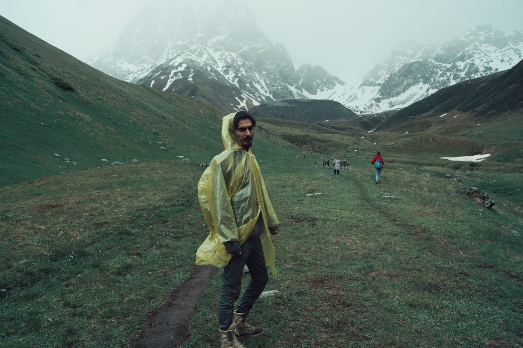 Hiker in Rain Gear at Juta Mountain Range, Georgia
