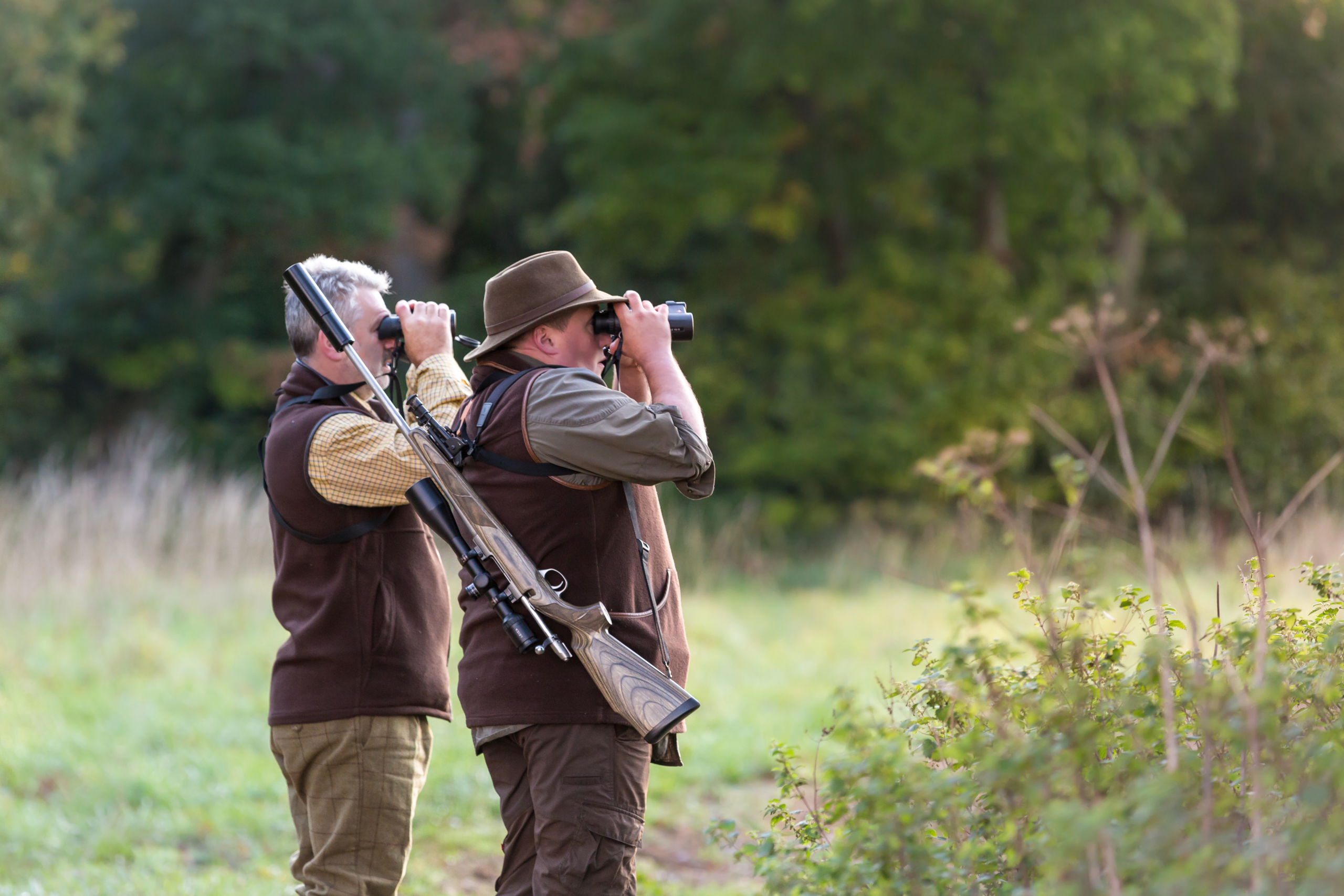 Two Person Looking Through Binoculars