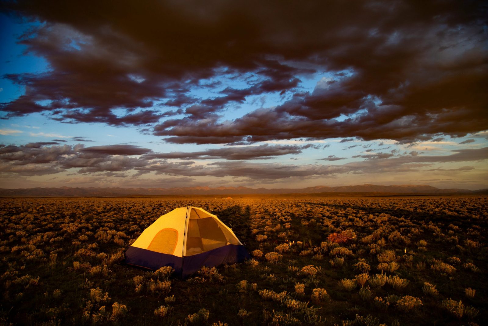 A vibrant sunset over a campsite in the Colorado desert, capturing nature's beauty.