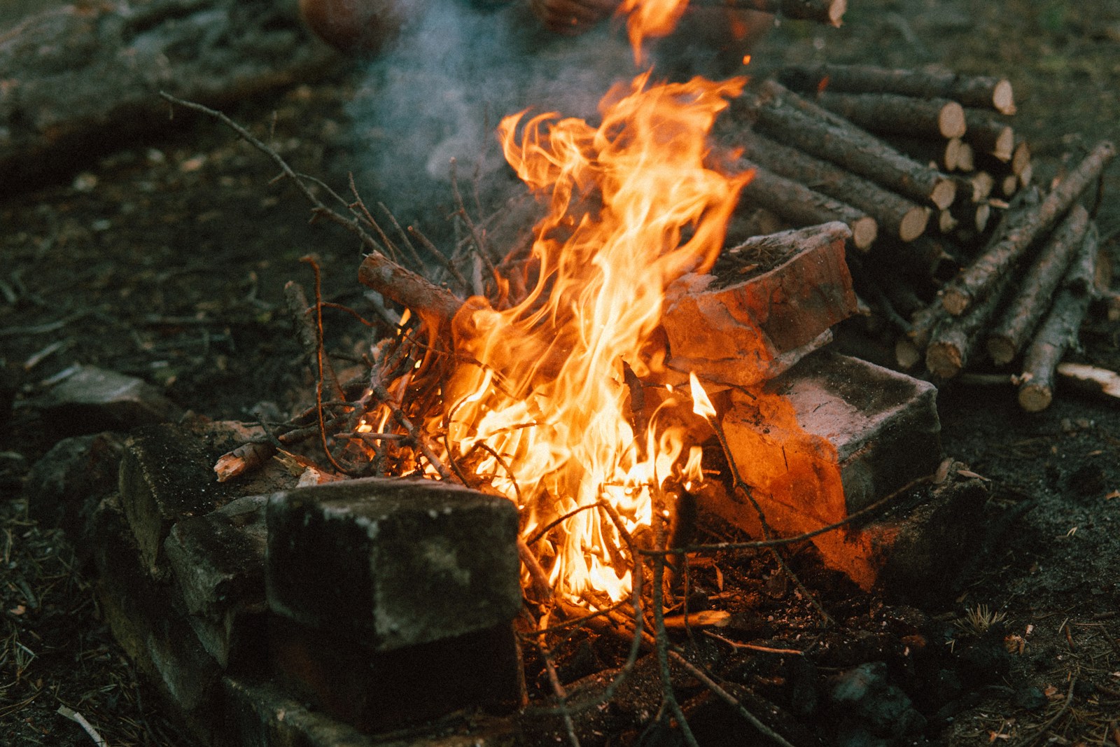 taiki-ishikawa-w6EMxsk8CDA-unsplash a fire burning in a pit