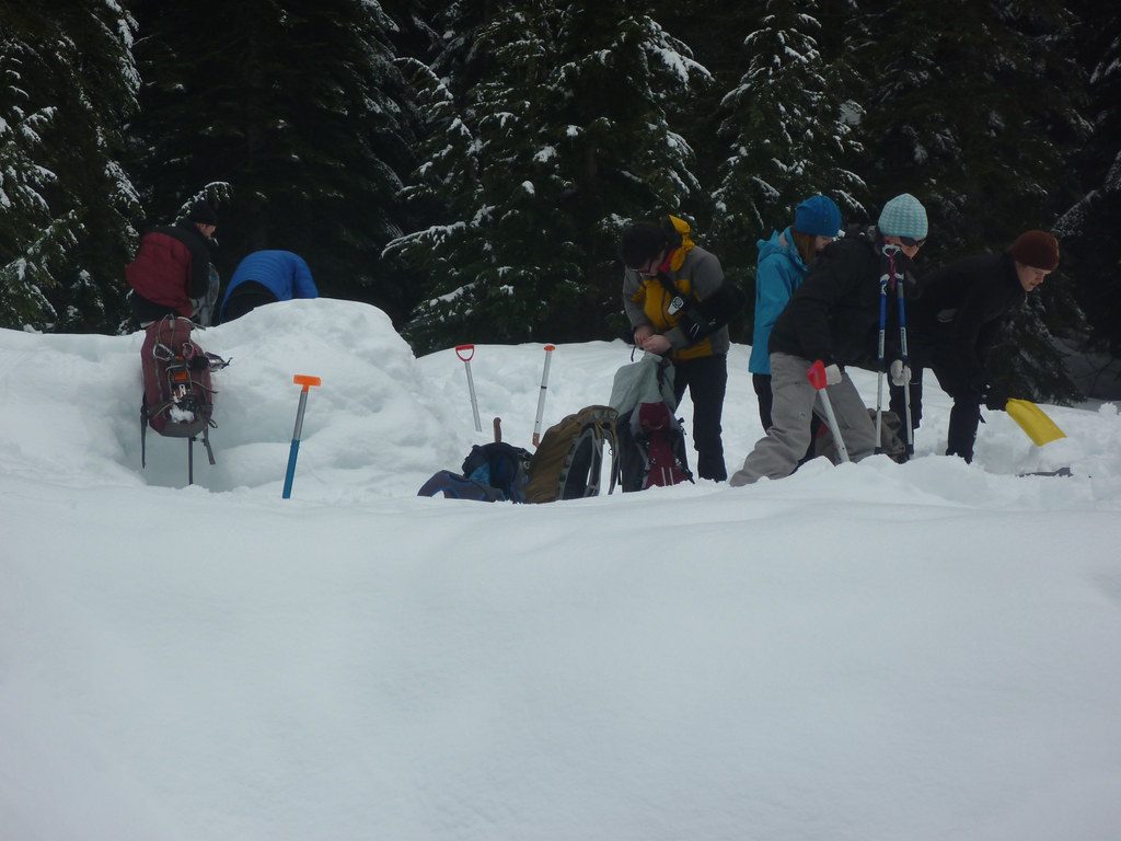 People Using shovel to get out of Snow Shelter