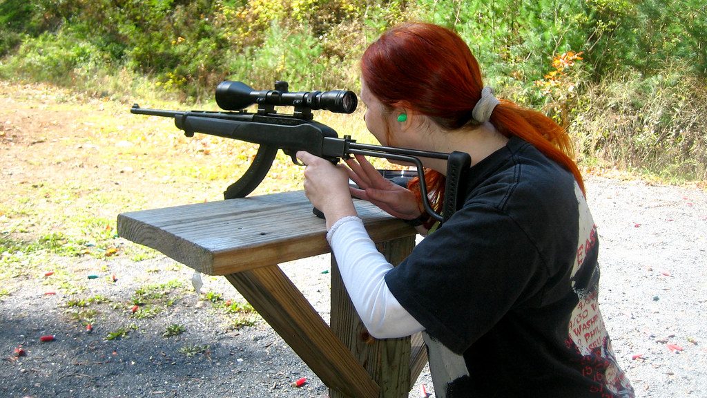 A woman Facing Rifle Recoil