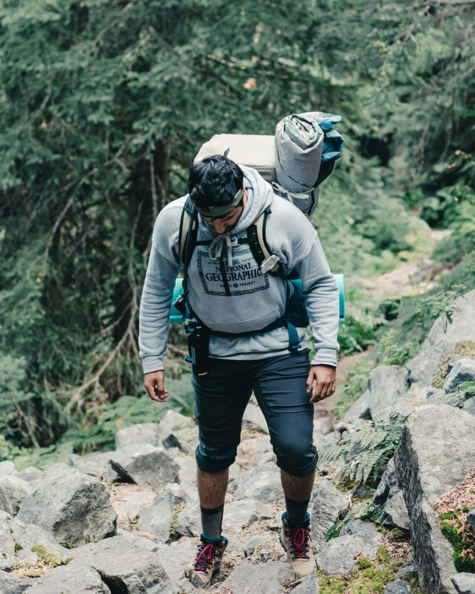 A male hiker on a rocky forest trail in British Columbia, Canada.