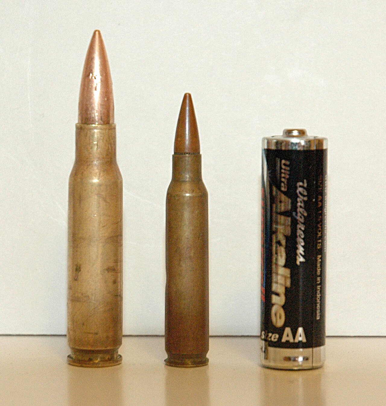 The 7.62×51mm NATO and 5.56×45mm NATO cartridges compared to an AA battery