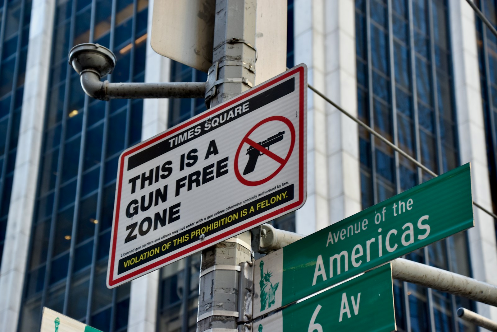Times square gun free zone sign with building background
