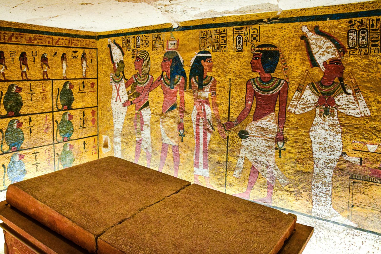 Detailed wall paintings inside the tomb of Tutankhamun featuring Egyptian mythology and art.