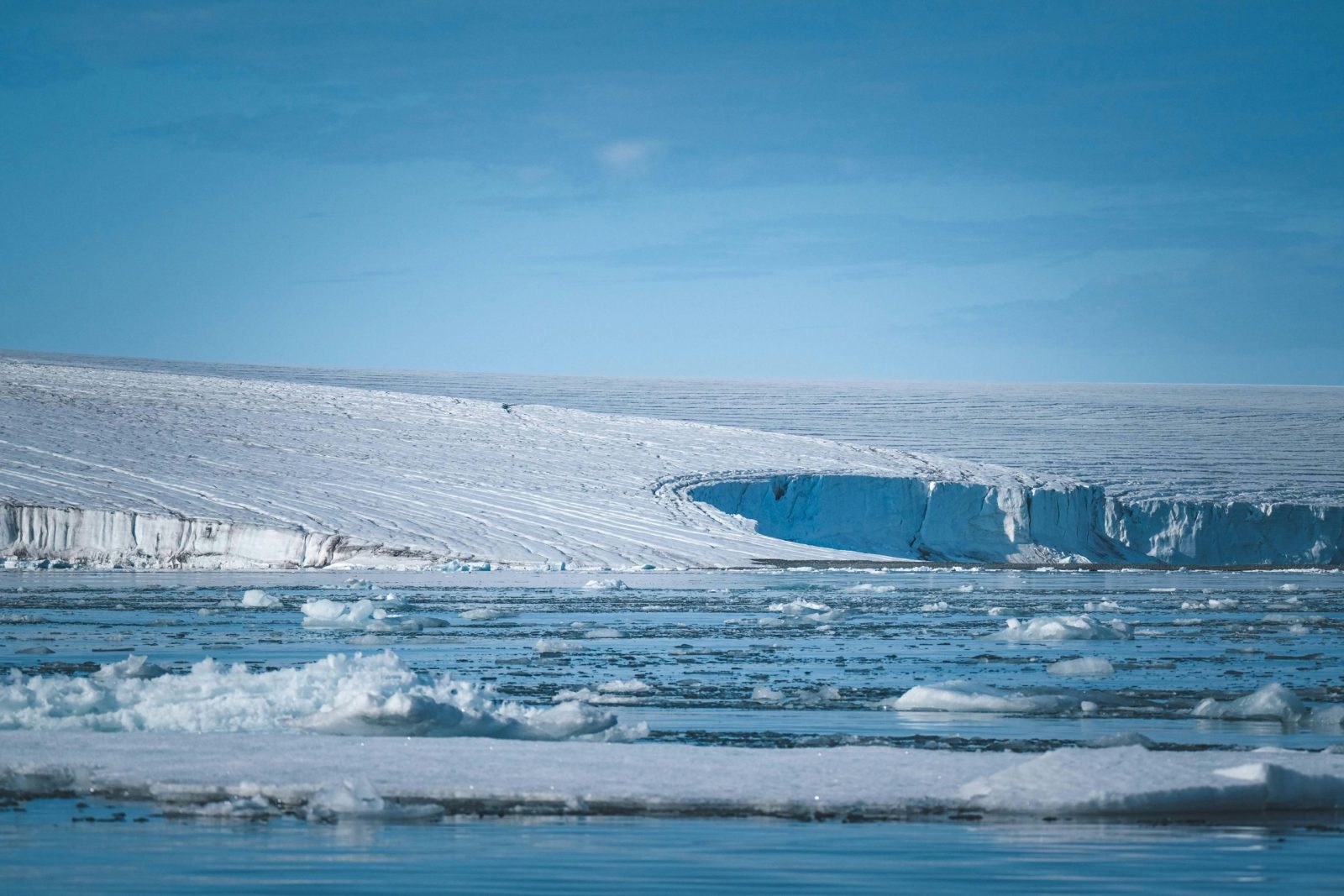 A breathtaking view of Arctic ice sheets under a clear blue sky, showcasing nature's cold beauty.
