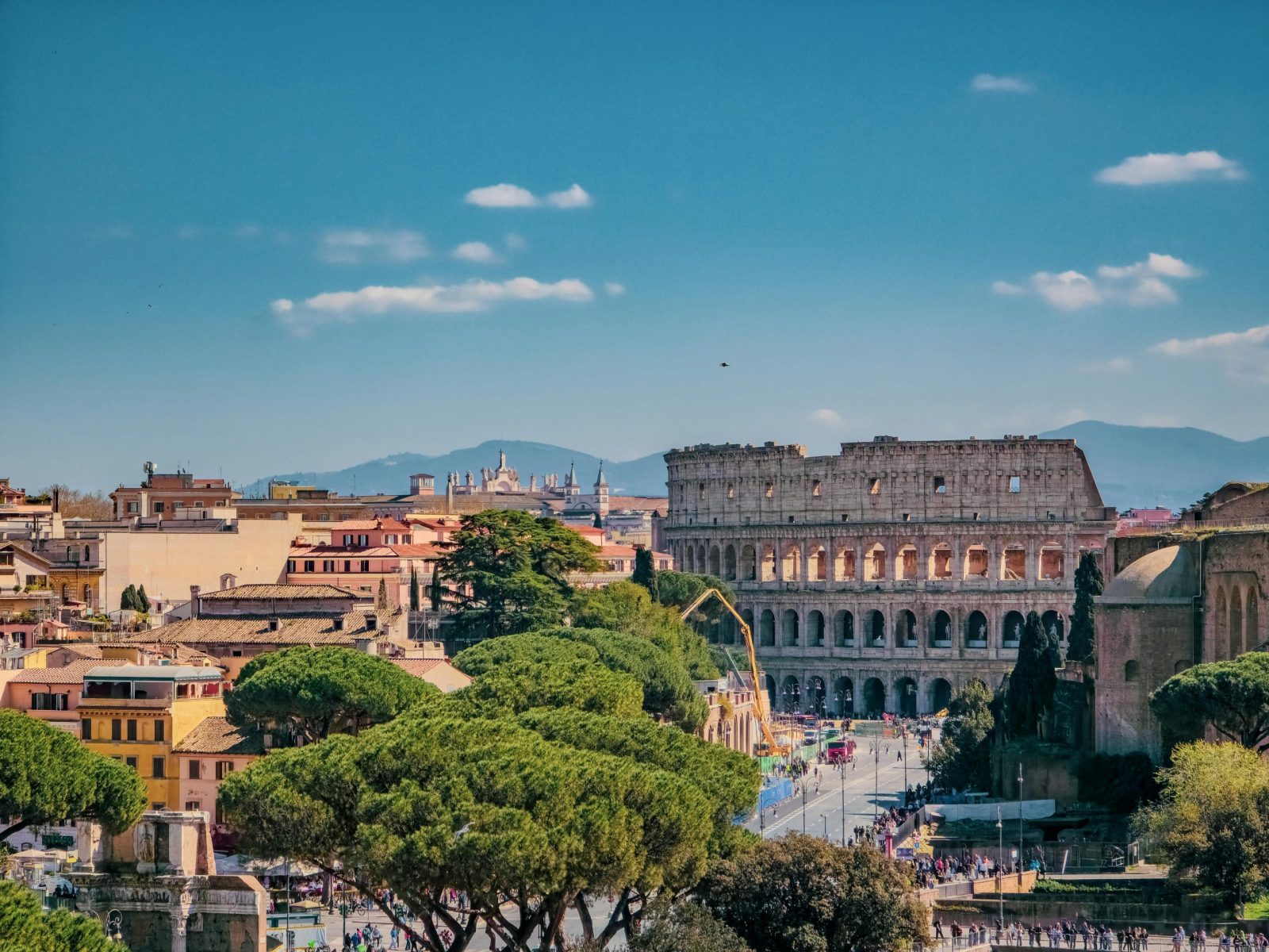 A breathtaking view of Rome featuring the iconic Colosseum on a sunny day.