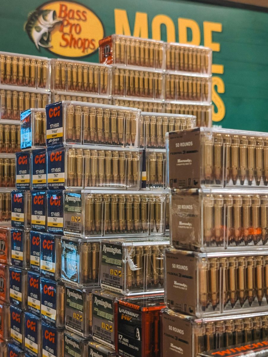 Piles of various brand ammunition boxes stacked at Bass Pro Shops store.