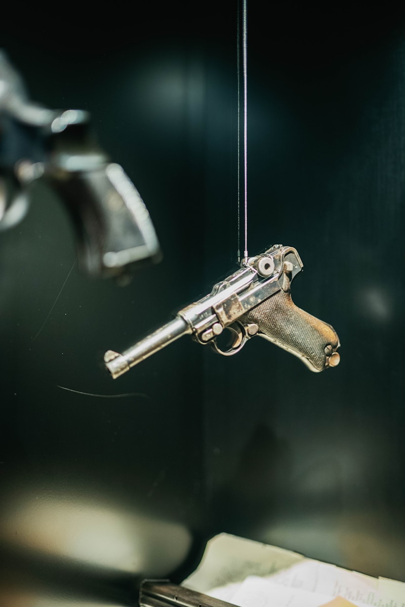 A gun hanging from a hook on a wall