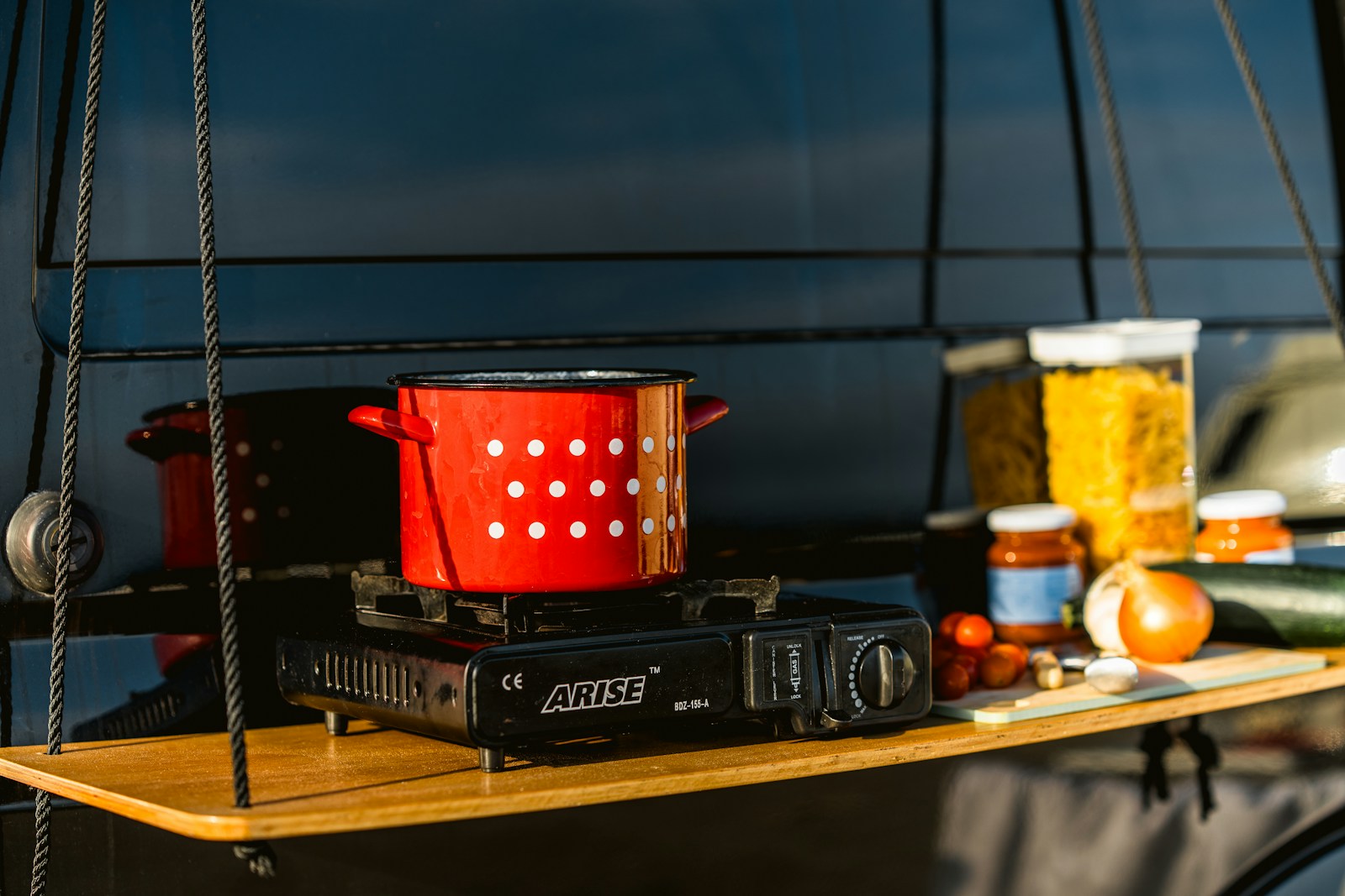 Red pot with white dots on portable stove