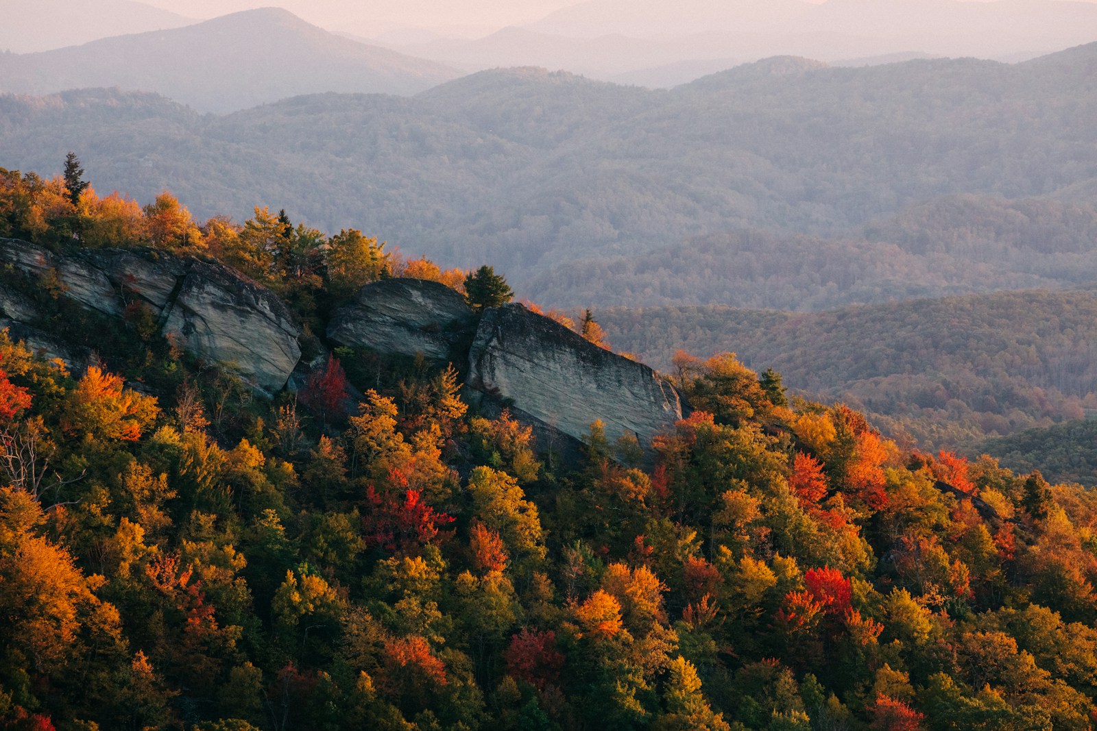 a scenic view of a mountain range in the fall
