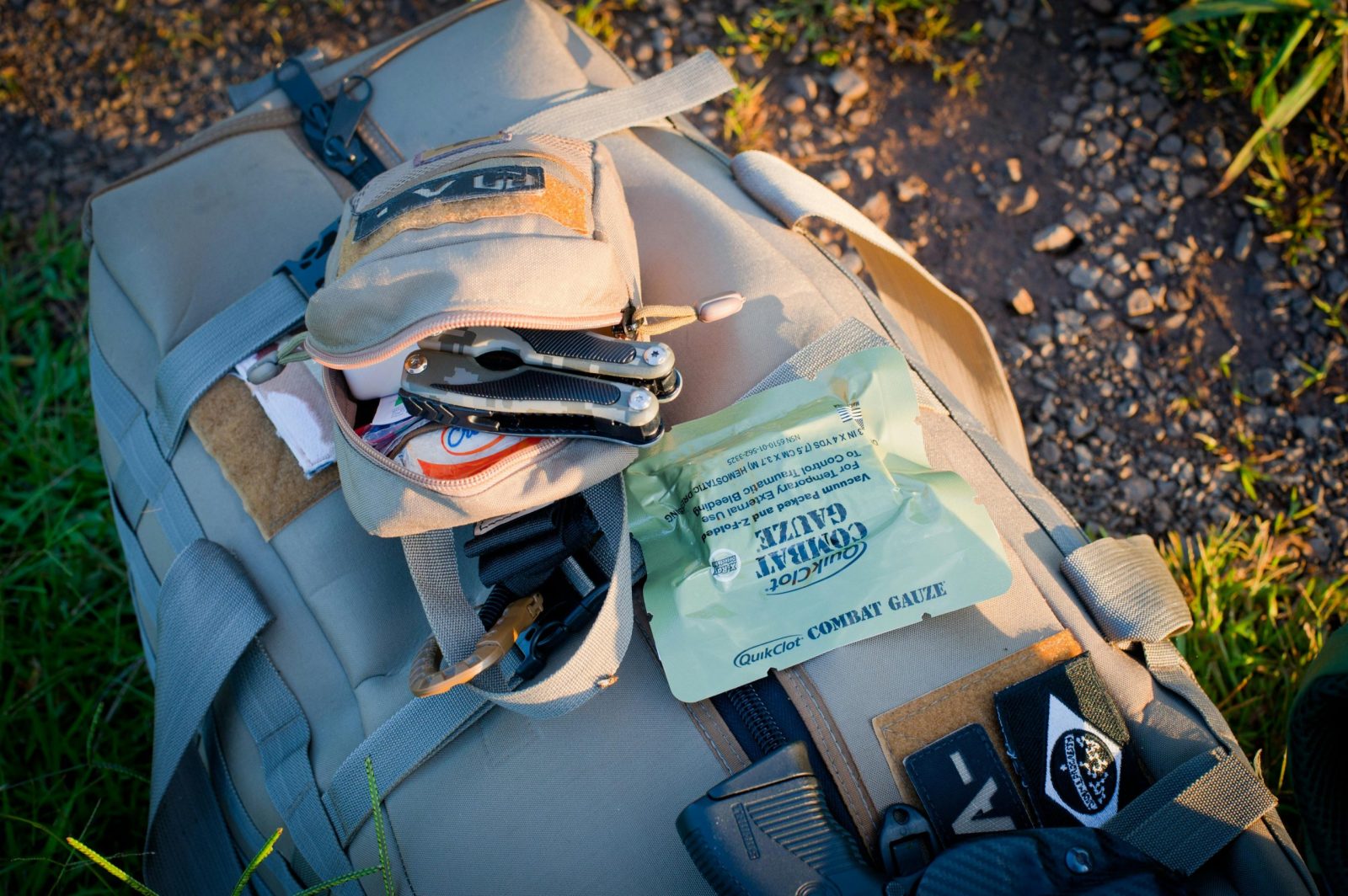 Essential outdoor gear featuring a backpack and first aid kit ready for adventure.