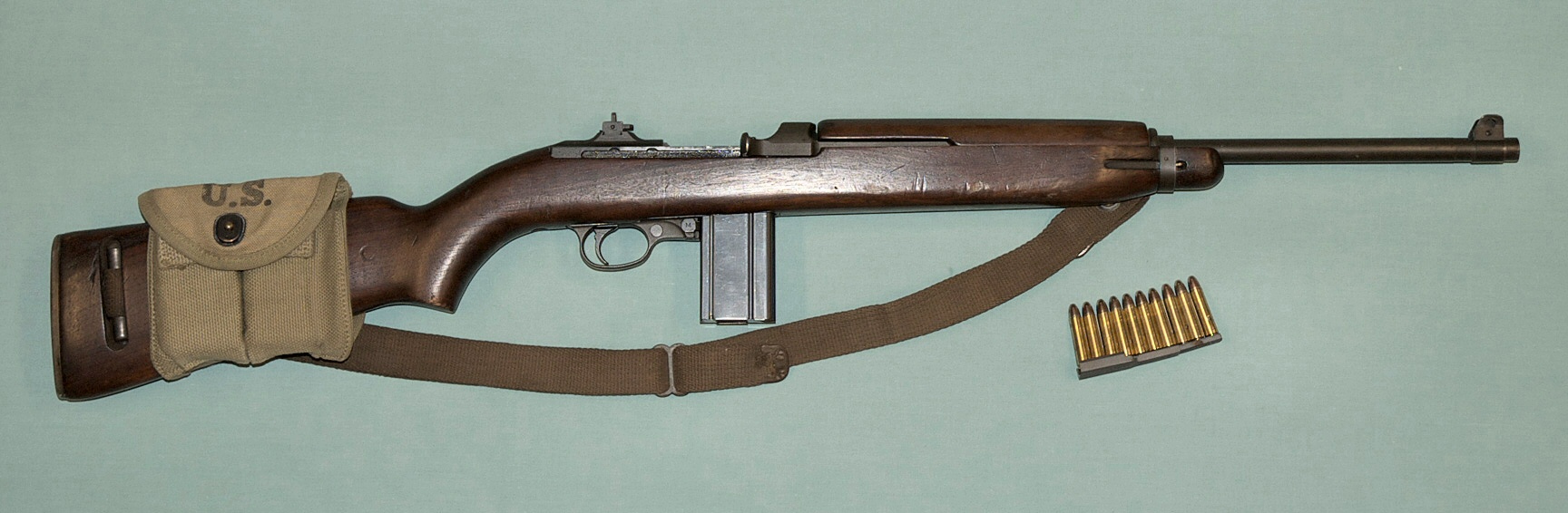 WW II M1 carbine with a magazine pouch mounted on the stock that held two spare 15-round magazines and 10 .30 carbine rounds on a stripper clip