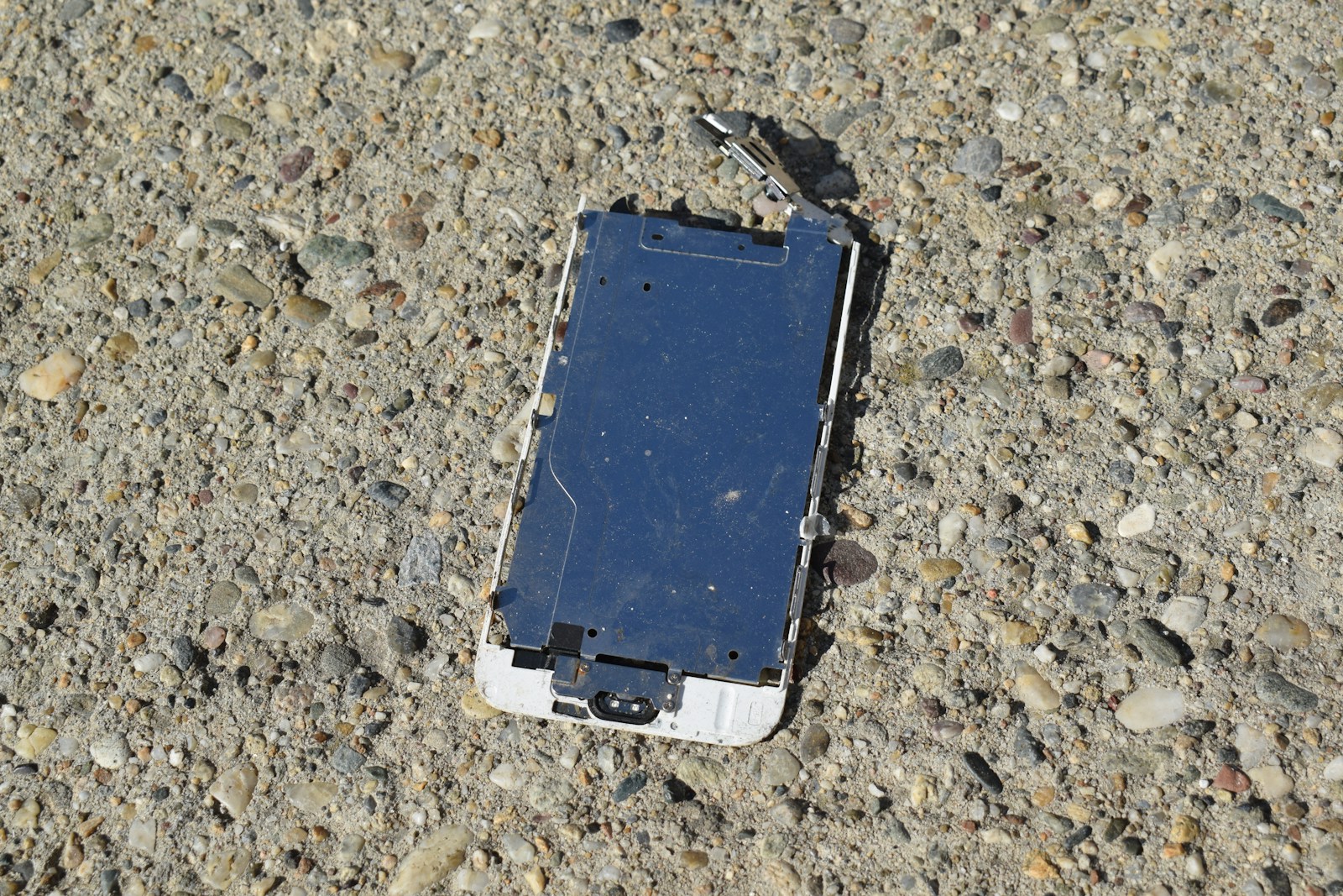 a broken cell phone laying on the ground