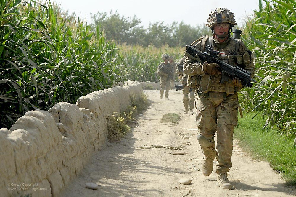 Soldier with SA80 and Underslung Grenade Launcher on Patrol in Afghanistan