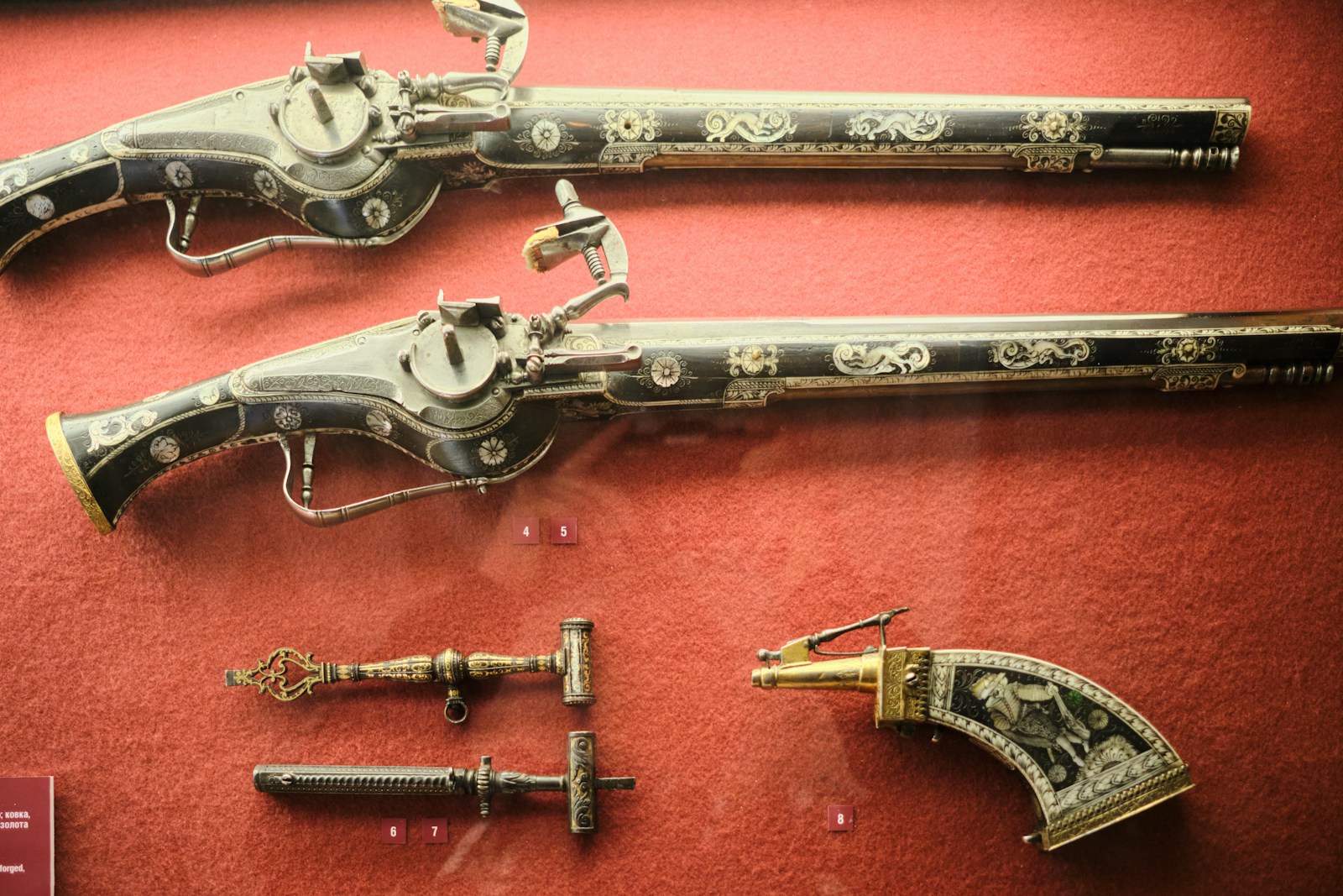 Antique pistols and tools are on display.